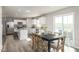 Spacious open concept kitchen and dining area with natural light and modern fixtures at 260 Day Farm Dr, Lillington, NC 27546