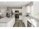 Bright kitchen with stainless steel appliances, white cabinets and granite countertops at 260 Day Farm Dr, Lillington, NC 27546