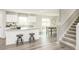 Open concept kitchen features an island with seating and a view of the dining area at 260 Day Farm Dr, Lillington, NC 27546