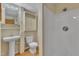 Compact basement bathroom equipped with a pedestal sink, toilet, medicine cabinet, and shower stall at 2600 Wade Ave, Raleigh, NC 27607