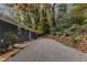 Long gravel driveway leading to the house with mature trees and shrubs for added privacy at 2600 Wade Ave, Raleigh, NC 27607