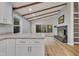 Kitchen island with granite countertops, white cabinets, and view into the living room with a fireplace at 2600 Wade Ave, Raleigh, NC 27607