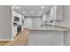 Bright kitchen features granite countertops, stainless steel appliances, and light wood flooring at 2600 Wade Ave, Raleigh, NC 27607