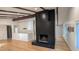 Spacious living room with high ceilings, dark wood beams, and black brick fireplace at 2600 Wade Ave, Raleigh, NC 27607