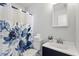 The bathroom features a blue floral shower curtain and a white countertop sink at 2835 Bedfordshire Ct, Raleigh, NC 27604