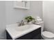 The bathroom features a white countertop sink, a plant, and neatly folded white towels at 2835 Bedfordshire Ct, Raleigh, NC 27604