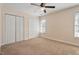 Bedroom with carpet, windows for light, ceiling fan, and double closets at 2835 Bedfordshire Ct, Raleigh, NC 27604