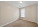Bedroom showcasing neutral walls and carpet, a window with natural light, and baseboard molding at 2835 Bedfordshire Ct, Raleigh, NC 27604