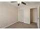 Bedroom with neutral walls, carpet, a ceiling fan, a window, a closet, and a doorway at 2835 Bedfordshire Ct, Raleigh, NC 27604