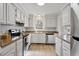 Bright kitchen with white cabinets, stainless steel appliances, and natural light at 2835 Bedfordshire Ct, Raleigh, NC 27604