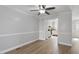 Bright living room showcases wood flooring, modern wall trim, and an open flow to the kitchen at 2835 Bedfordshire Ct, Raleigh, NC 27604