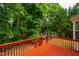 Inviting back deck with red wood and green outdoor views at 303 Laurens Way, Chapel Hill, NC 27516