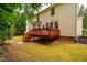 Expansive backyard features a back deck, patio, and green grass at 303 Laurens Way, Chapel Hill, NC 27516