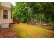 A spacious backyard features a deck, garden, and plenty of yard space at 303 Laurens Way, Chapel Hill, NC 27516