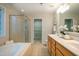 Bathroom with tub and shower, double sinks, and tile flooring at 303 Laurens Way, Chapel Hill, NC 27516