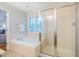 Bathroom featuring a shower, large soaking tub, window, and modern fixtures at 303 Laurens Way, Chapel Hill, NC 27516