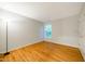 This bedroom features hardwood floors, a window with a view, and neutral-colored walls at 303 Laurens Way, Chapel Hill, NC 27516