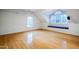 Bright bonus room with hardwood floors, built-in window seat, and natural light at 303 Laurens Way, Chapel Hill, NC 27516