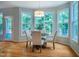 Bright dining area featuring large windows and hardwood floors, perfect for Gathering meals and entertaining at 303 Laurens Way, Chapel Hill, NC 27516