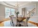 Dining area with a large window, modern lighting, and seating for six at 303 Laurens Way, Chapel Hill, NC 27516