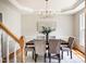 Elegant dining room with tray ceilings, stylish chandelier, and seating for six at 303 Laurens Way, Chapel Hill, NC 27516