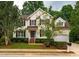 Charming two-story home features a well-manicured lawn and classic architectural details at 303 Laurens Way, Chapel Hill, NC 27516