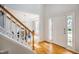 Welcoming foyer with gleaming hardwood floors and staircase is adjacent to the dining room at 303 Laurens Way, Chapel Hill, NC 27516