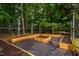 The backyard features raised garden beds in a fenced area, ready for planting at 303 Laurens Way, Chapel Hill, NC 27516