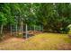 Backyard features raised garden beds in a fenced in area at 303 Laurens Way, Chapel Hill, NC 27516