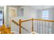Bright hallway with hardwood floors and white railing leading to bedrooms and bathrooms at 303 Laurens Way, Chapel Hill, NC 27516