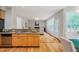 Open concept kitchen with wood cabinets, granite counters, and stainless steel appliances at 303 Laurens Way, Chapel Hill, NC 27516