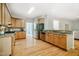 Spacious kitchen with wooden cabinets, granite countertops, stainless steel appliances, and hardwood flooring at 303 Laurens Way, Chapel Hill, NC 27516