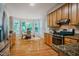 Well-lit kitchen with stainless steel appliances, granite countertops, and breakfast nook at 303 Laurens Way, Chapel Hill, NC 27516