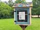 Neighborhood 'take a book, leave a book' library on a well-manicured lawn at 303 Laurens Way, Chapel Hill, NC 27516
