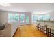 Bright living area features hardwood floors, large windows, and a breakfast bar with seating at 303 Laurens Way, Chapel Hill, NC 27516