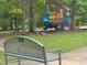 A colorful playground surrounded by trees and seating at 303 Laurens Way, Chapel Hill, NC 27516
