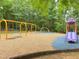 Outdoor playground area featuring swings and a slide, all nestled within a lush, green setting at 303 Laurens Way, Chapel Hill, NC 27516
