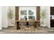 Bright dining area with modern table and chairs near a large window at 308 Canyon Spring Trl, Wake Forest, NC 27587