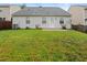Well-maintained backyard featuring a grassy area and the rear exterior of the home at 3108 Forrestal Dr, Durham, NC 27703