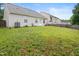 View of the backyard displaying the rear of the house and ample green space at 3108 Forrestal Dr, Durham, NC 27703