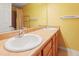 Well-lit bathroom featuring double sinks, mirror and light wood cabinets at 3108 Forrestal Dr, Durham, NC 27703