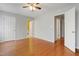 Spacious bedroom with gleaming hardwood floors, ceiling fan, and two doorways at 3108 Forrestal Dr, Durham, NC 27703