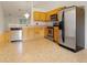 Well-lit kitchen with stainless steel appliances, tile floor and light wood cabinets at 3108 Forrestal Dr, Durham, NC 27703