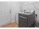 Bright laundry room with washer, dryer, shelving, and white door at 3108 Forrestal Dr, Durham, NC 27703
