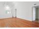 Bright, open-concept living room featuring hardwood floors, a chandelier, and view of an interior doorway at 3108 Forrestal Dr, Durham, NC 27703