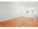 Bright, open-concept living room with hardwood floors, high ceilings, chandelier, and a view to an open doorway at 3108 Forrestal Dr, Durham, NC 27703