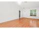 Bright, open-concept living room with hardwood floors, high ceilings, chandelier, and a view to the front door at 3108 Forrestal Dr, Durham, NC 27703
