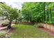 A fenced backyard featuring a well-manicured lawn and a patio area, perfect for outdoor entertaining at 3304 Rockland Ridge Dr, Cary, NC 27519