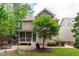 Backyard with a patio, a screened in porch, a well manicured lawn and mature landscaping at 3304 Rockland Ridge Dr, Cary, NC 27519