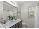 Bathroom featuring a double sink vanity, tile floors, decorative mirror, and a framed window at 3304 Rockland Ridge Dr, Cary, NC 27519